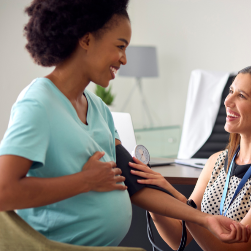 a pregnant woman getting her blood pressure checked