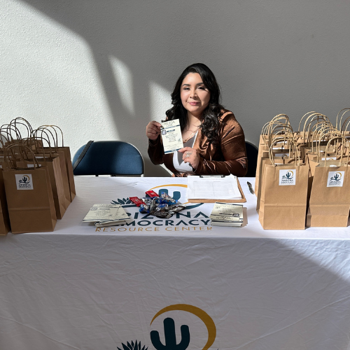a woman sitting at a table with gift bags